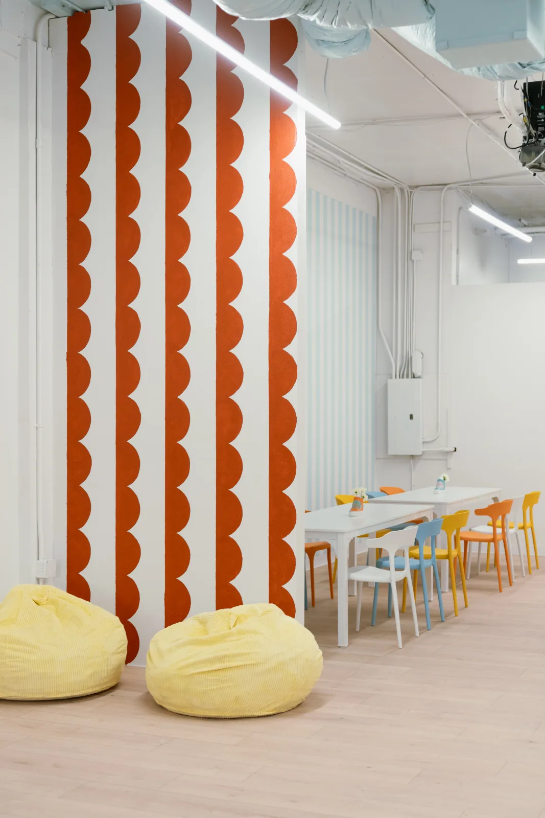 The bean bag corner beside the orange scalloped wall at Lemur Lulu party venue near Seattle