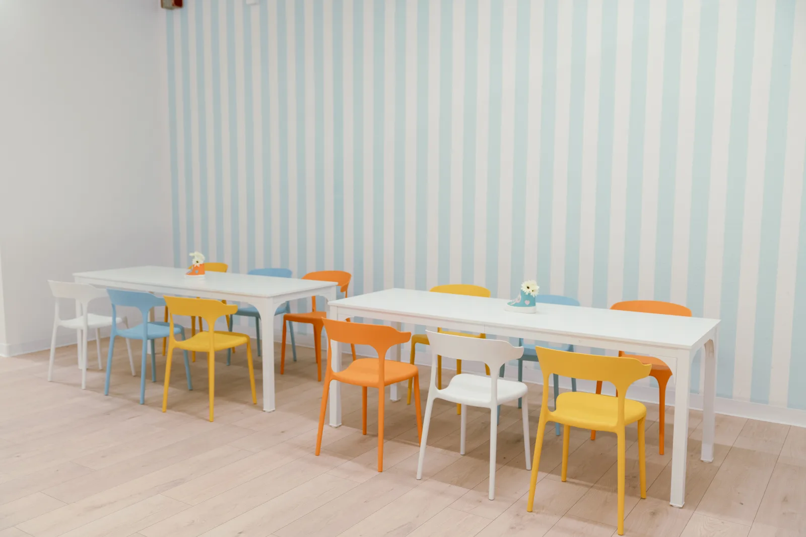 Tables and colourful chairs set up and ready at Lemur Lulu private party room near Seattle